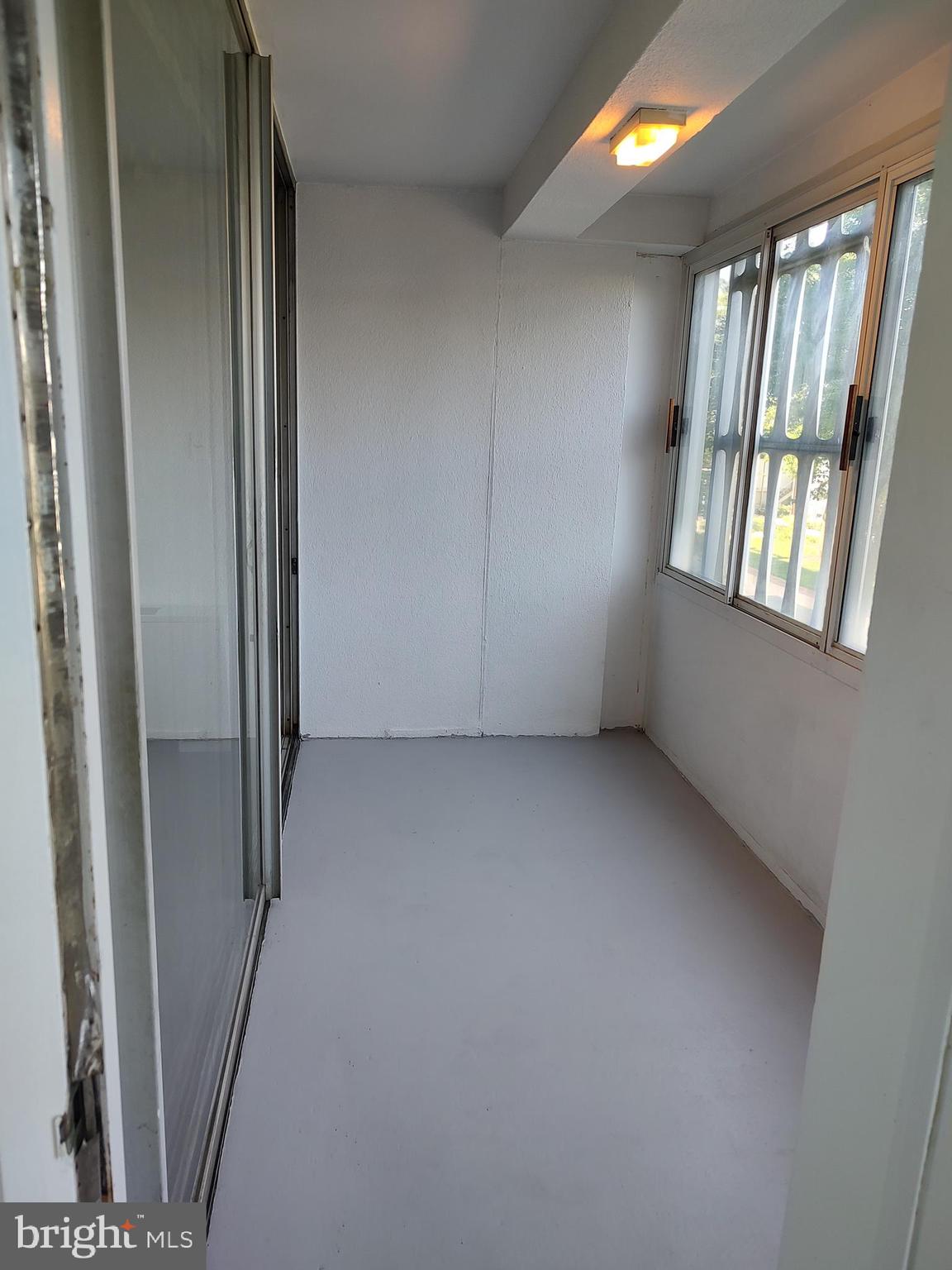 1301 Delaware Avenue Southwest, Unit N103 Washington, DC 20024 - Photo 16 of 26 an empty room with windows