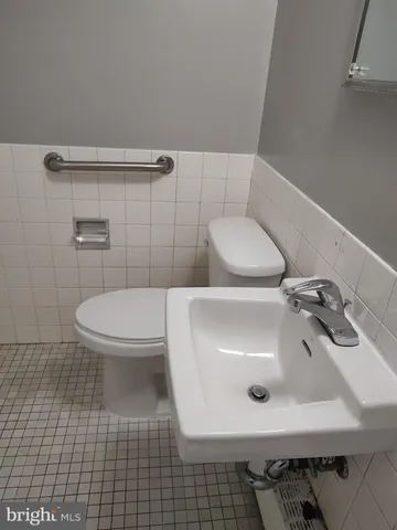 a bathroom with a sink a toilet and mirror