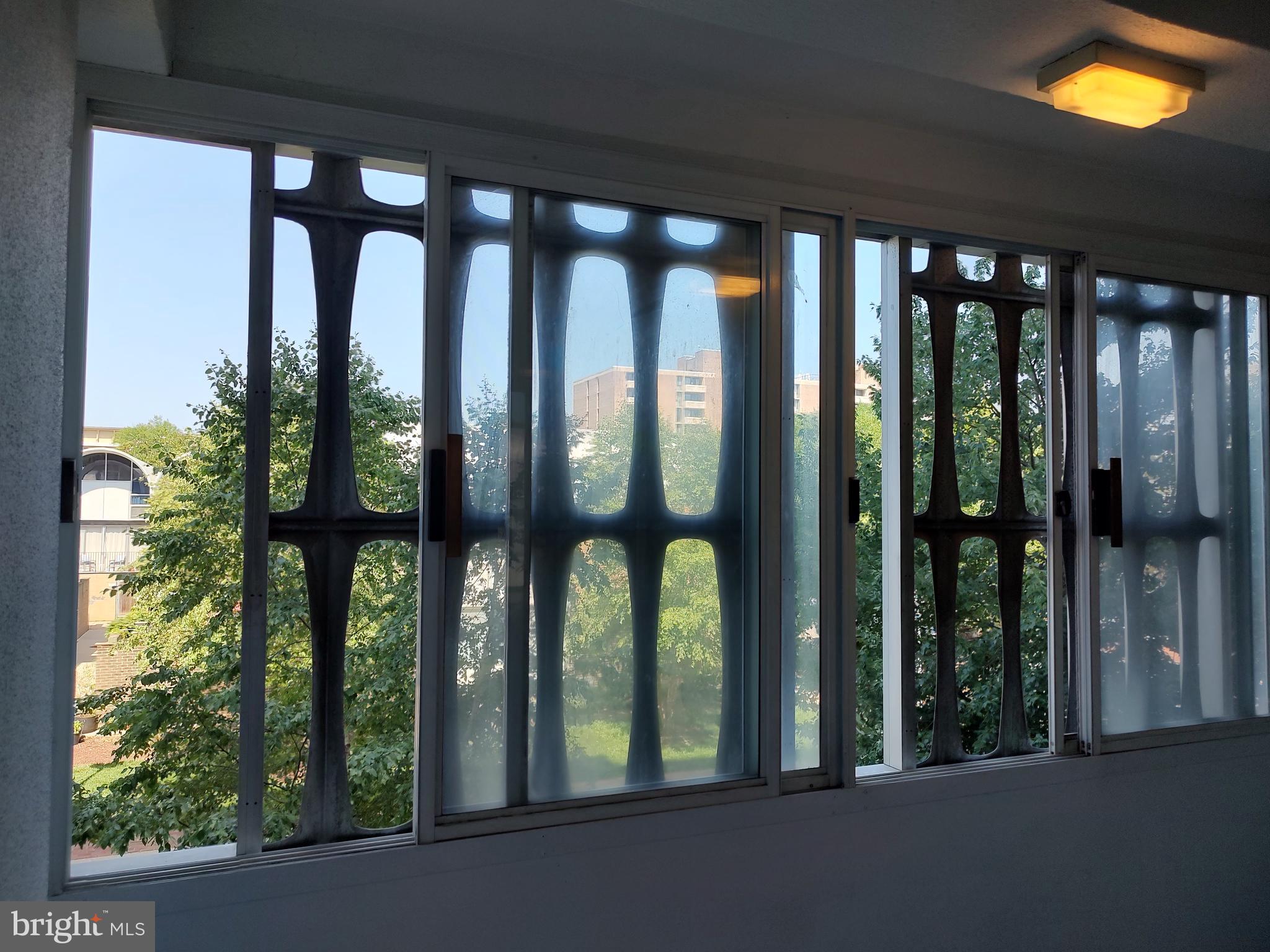 1301 Delaware Avenue Southwest, Unit N103 Washington, DC 20024 - Photo 3 of 26 a view of porch with a floor to ceiling window and wooden floor