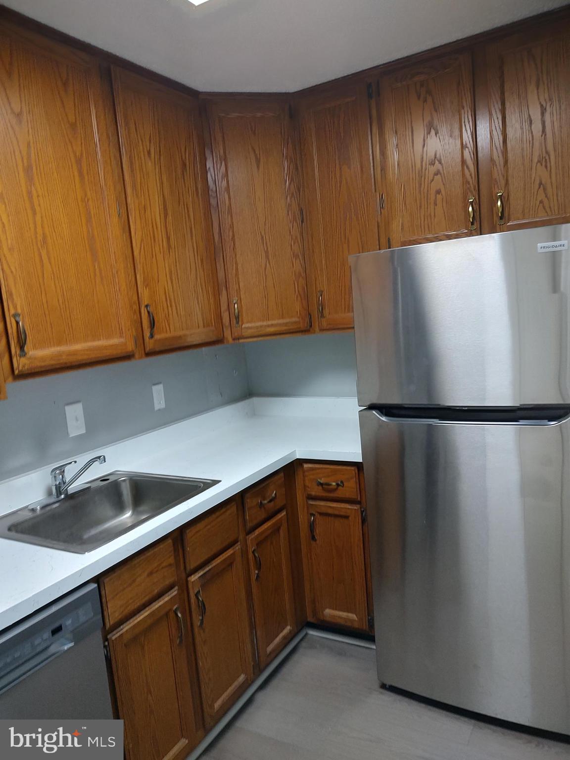 1301 Delaware Avenue Southwest, Unit N103 Washington, DC 20024 - Photo 5 of 26 a kitchen with a refrigerator and cabinets