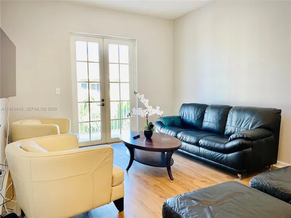 a spacious bedroom with a bed and a ceiling fan