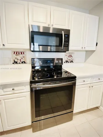 a living room with furniture and a lamp