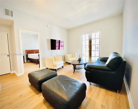a living room with furniture and a large window