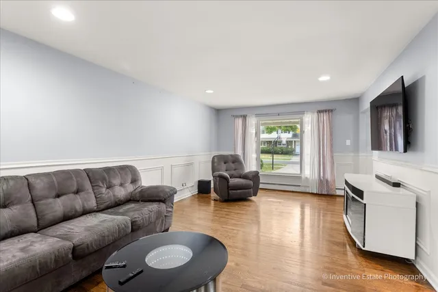 a view of a dining room with furniture wooden floor and chandelier