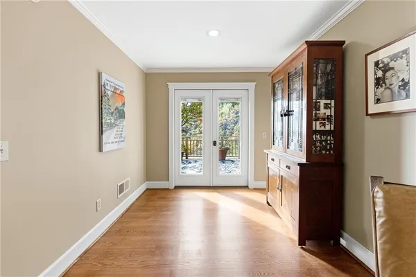 a living room with furniture and floor to ceiling windows