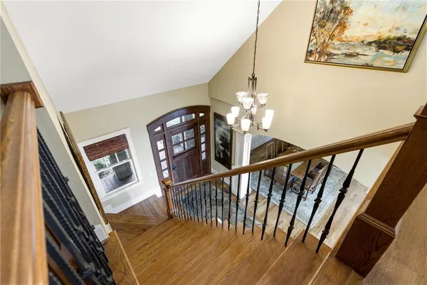 a living room with furniture a large window and a chandelier