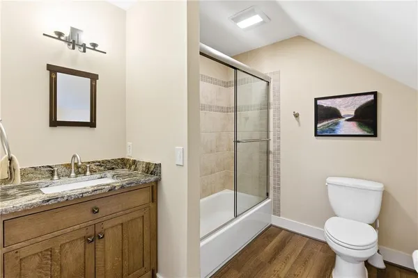 a bathroom with a toilet a sink and mirror