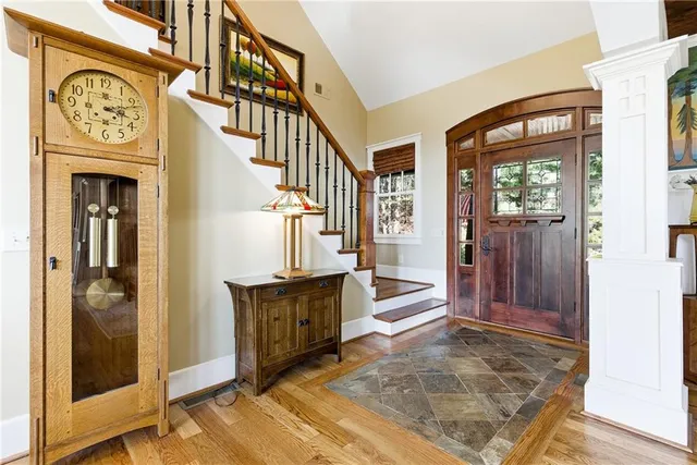 a living room with furniture fireplace and a large window