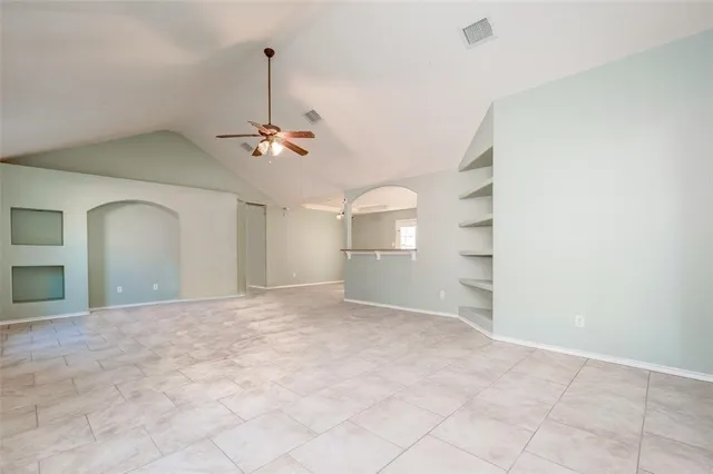 a view of a room with a ceiling fan