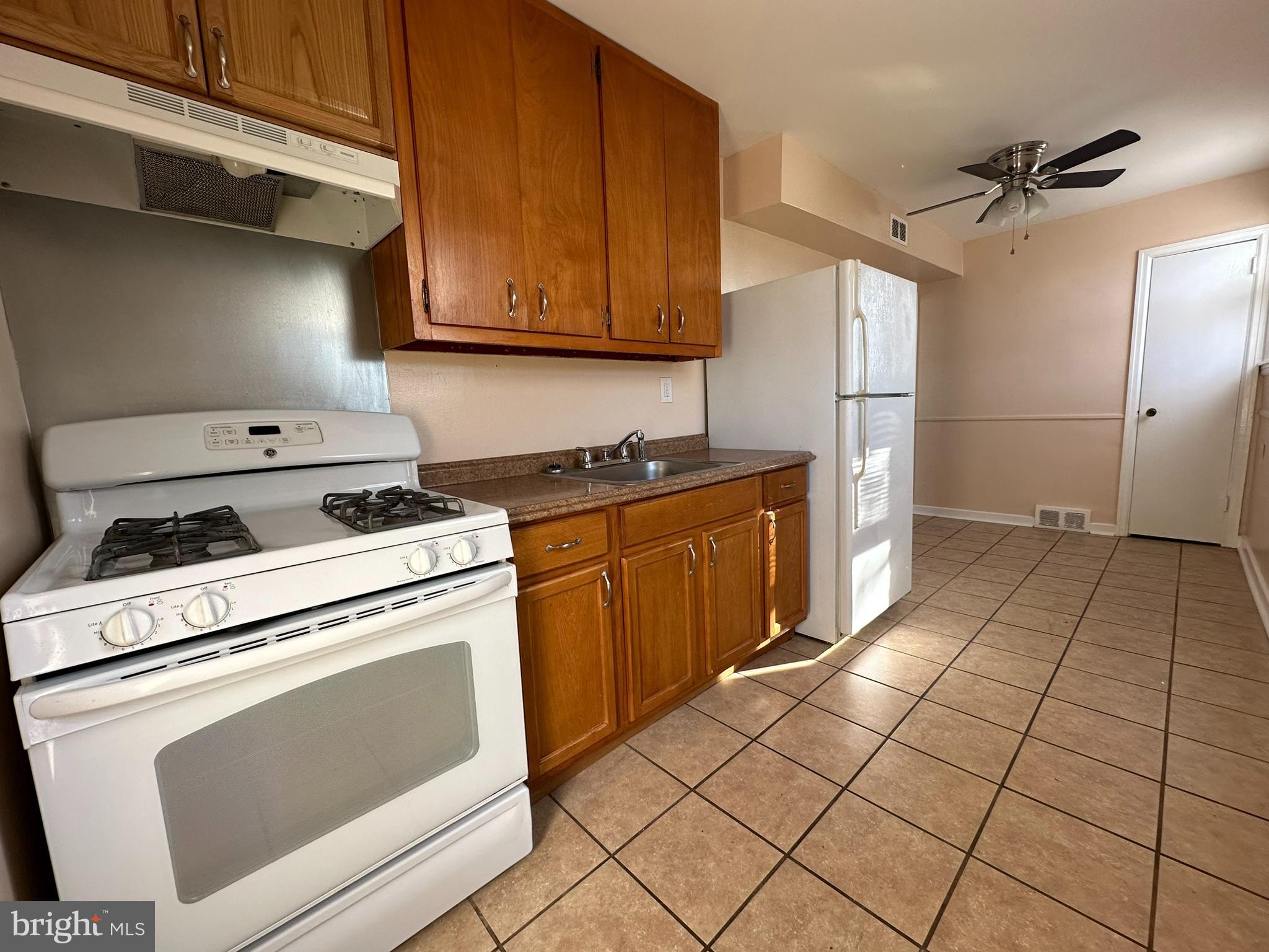 517 East Tabor Road, Unit 2 Philadelphia, PA 19120 - Photo 11 of 23 a kitchen with appliances cabinets and a stove top oven