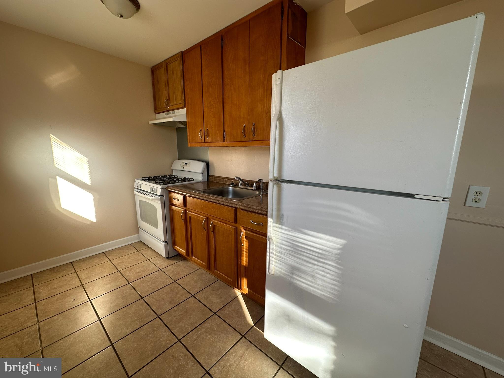 517 East Tabor Road, Unit 2 Philadelphia, PA 19120 - Photo 12 of 23 a kitchen with stainless steel appliances a stove a refrigerator a sink and cabinets