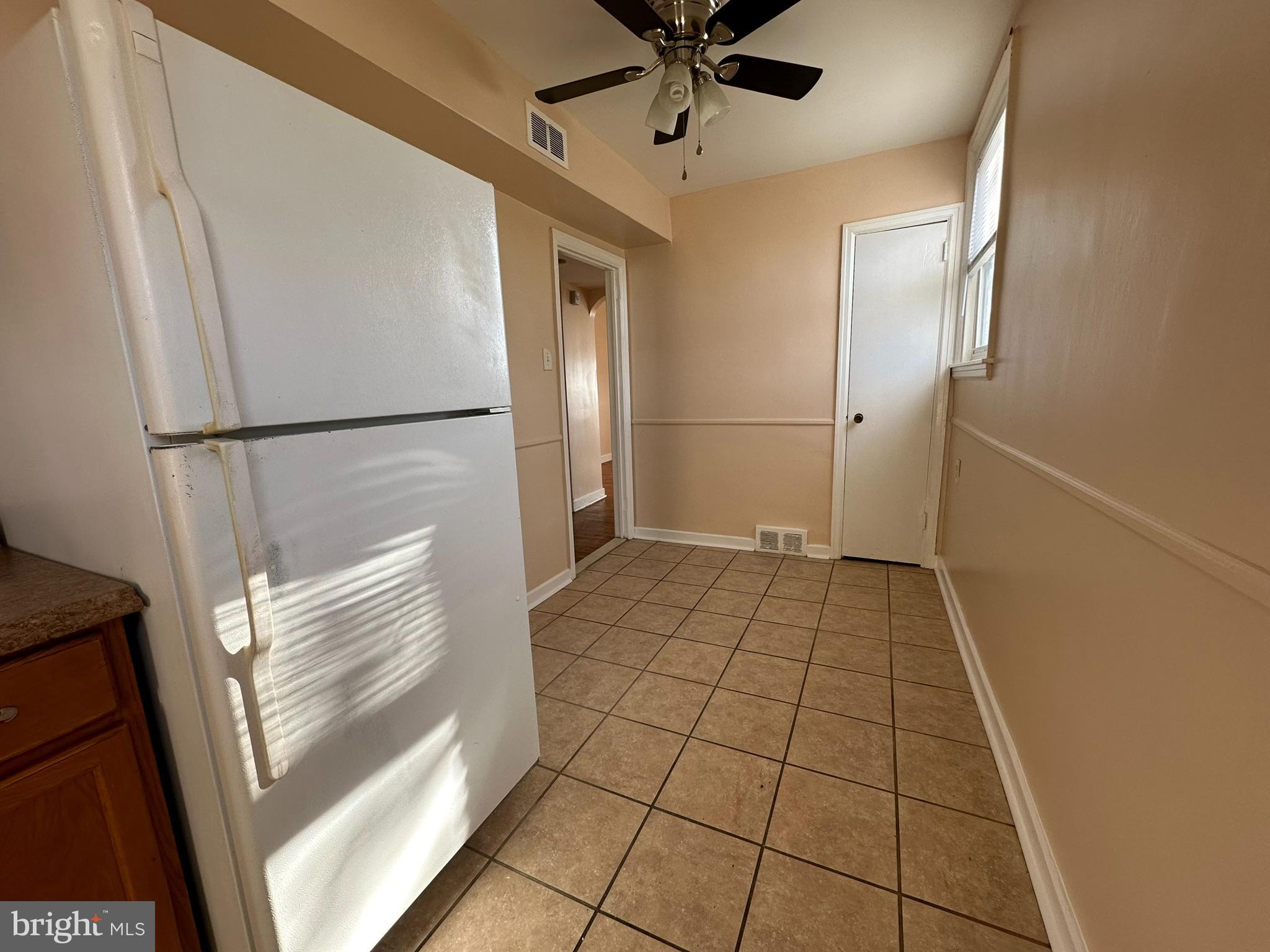 517 East Tabor Road, Unit 2 Philadelphia, PA 19120 - Photo 13 of 23 a view of a refrigerator in kitchen and an empty room