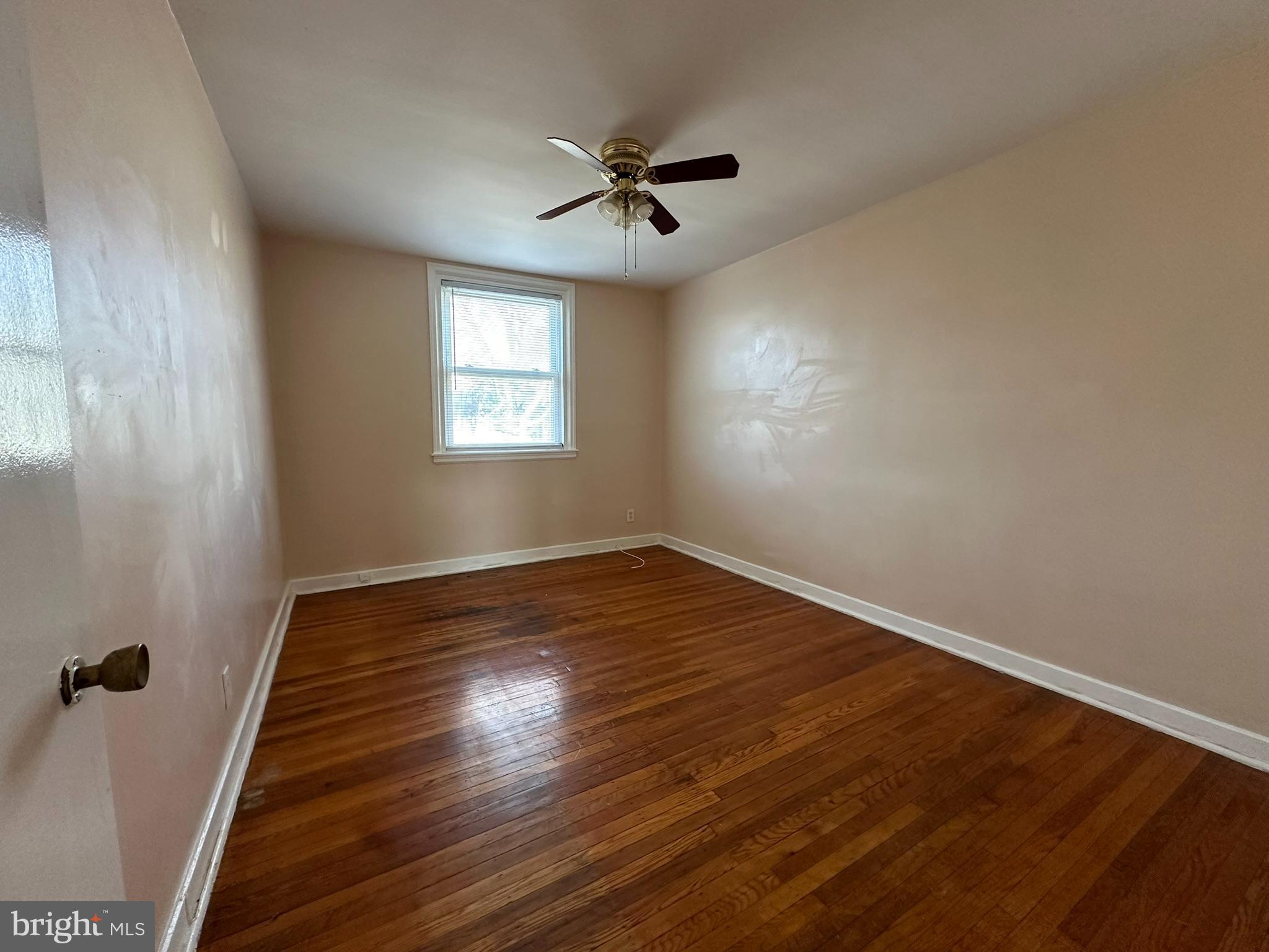 517 East Tabor Road, Unit 2 Philadelphia, PA 19120 - Photo 15 of 23 a view of an empty room with wooden floor and a window