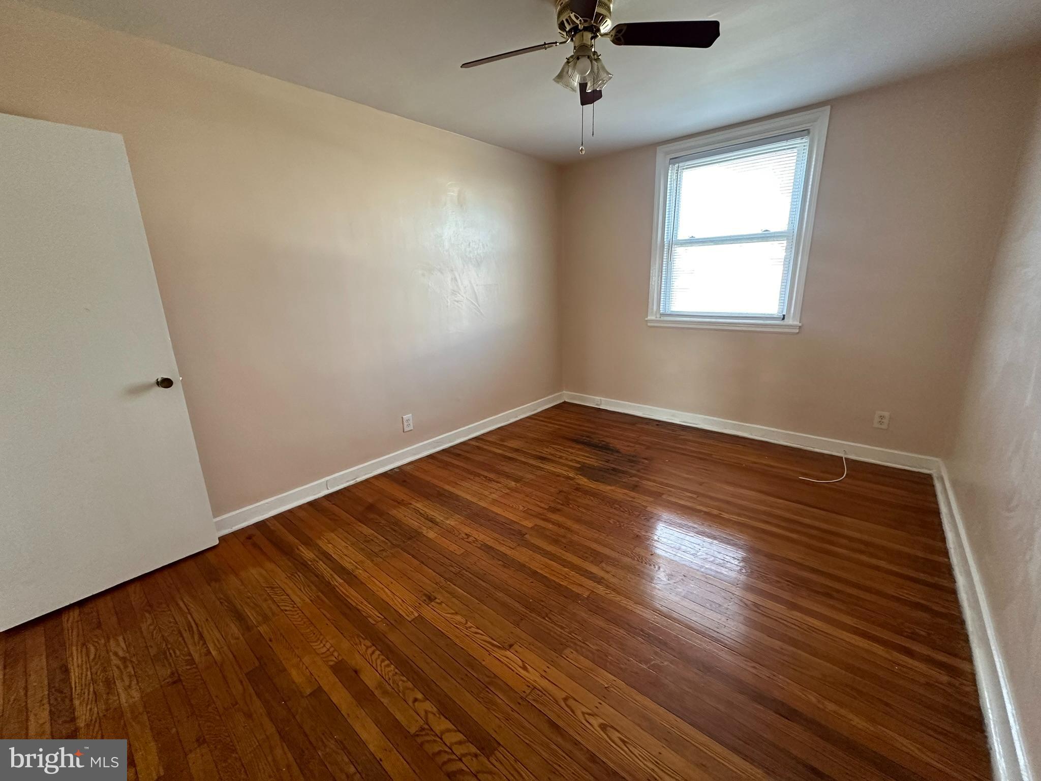 517 East Tabor Road, Unit 2 Philadelphia, PA 19120 - Photo 18 of 23 a view of an empty room with wooden floor and a window