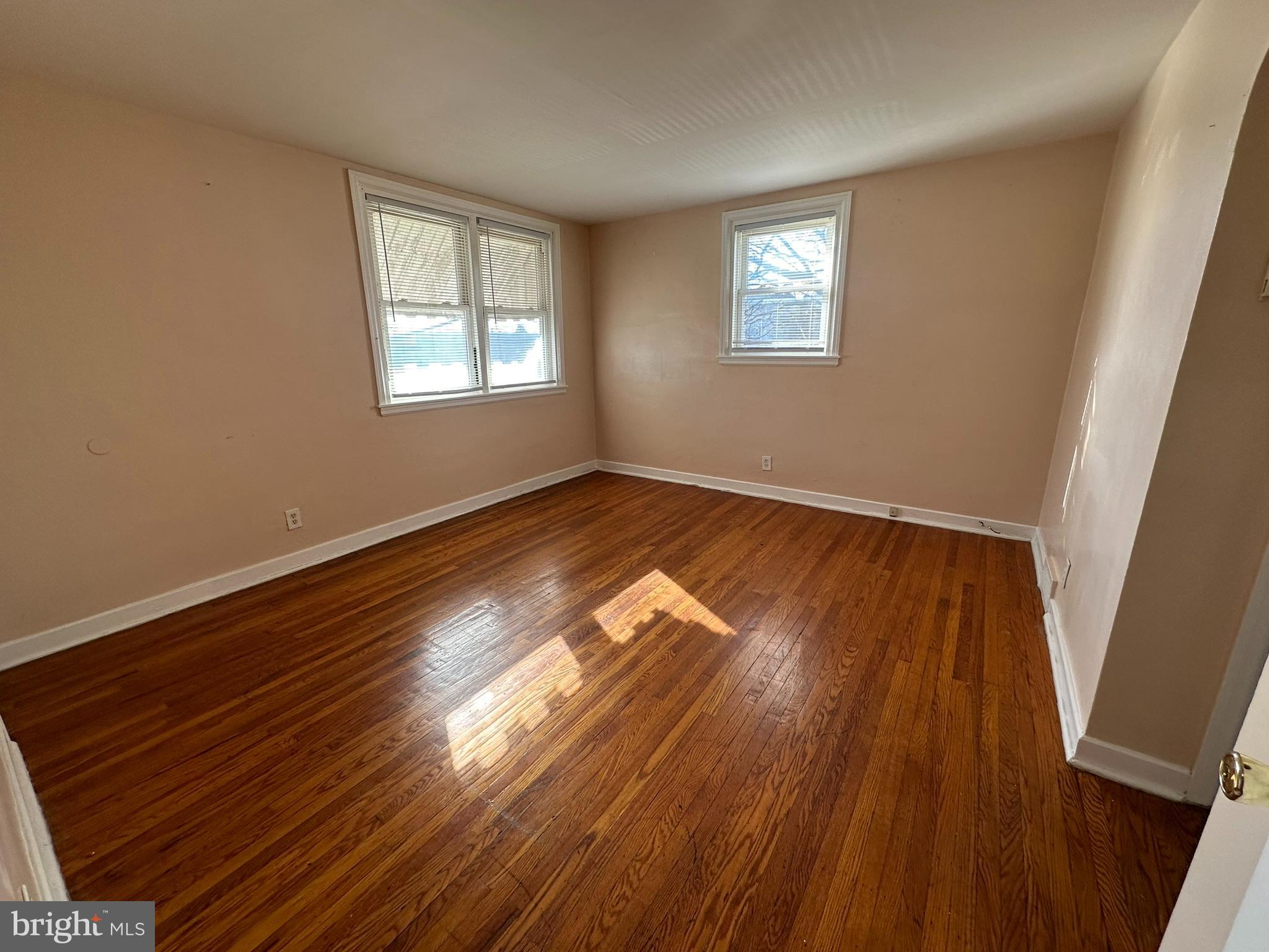 517 East Tabor Road, Unit 2 Philadelphia, PA 19120 - Photo 3 of 23 a view of an empty room with wooden floor and a window