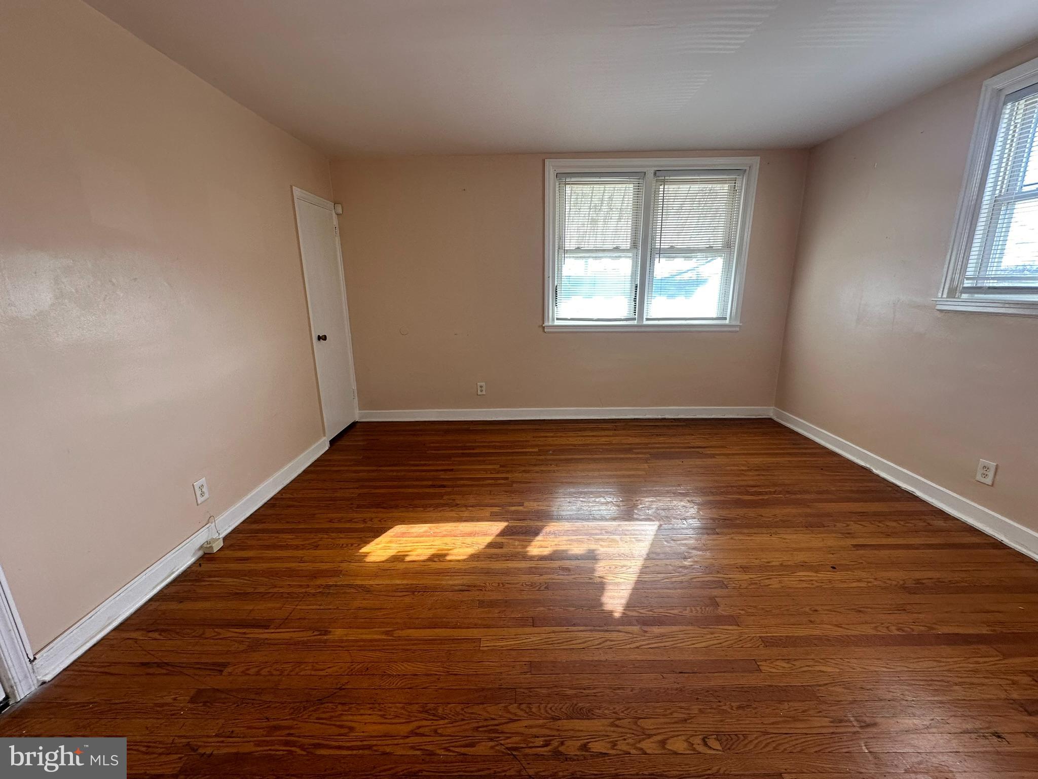 517 East Tabor Road, Unit 2 Philadelphia, PA 19120 - Photo 4 of 23 a view of empty room with window and wooden floor