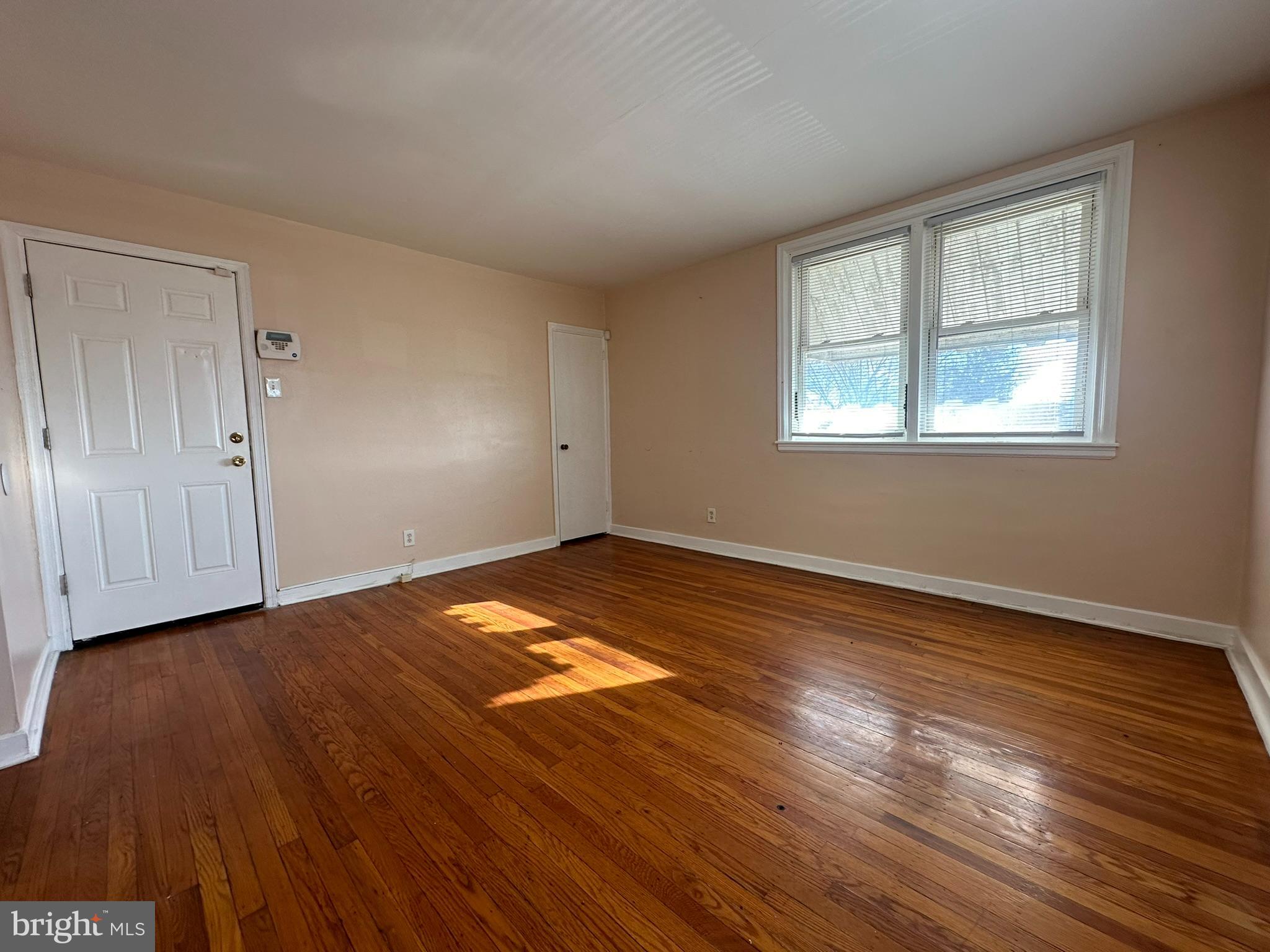 517 East Tabor Road, Unit 2 Philadelphia, PA 19120 - Photo 5 of 23 a view of empty room with wooden floor and fan