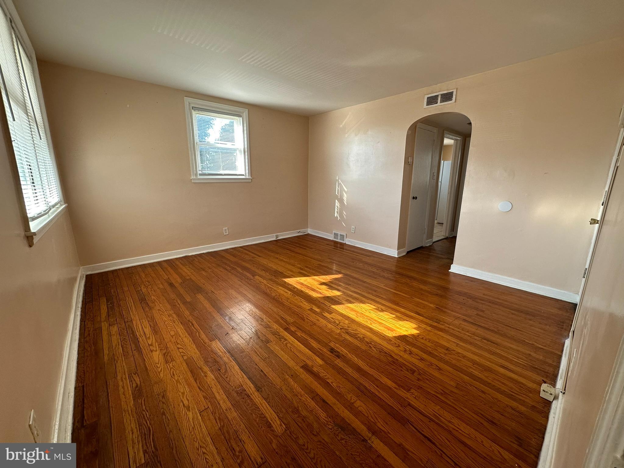 517 East Tabor Road, Unit 2 Philadelphia, PA 19120 - Photo 6 of 23 a view of an empty room with wooden floor and a window