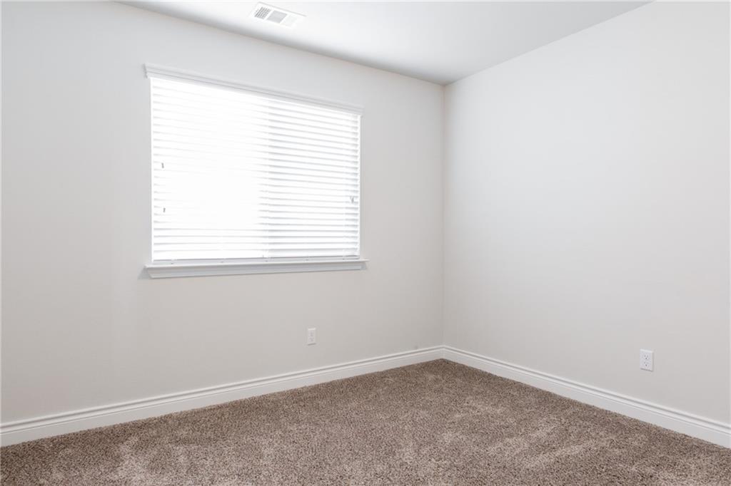 2104 Pindos Pony Way Georgetown, TX 78626 - Photo 20 of 30 A well-lit, neutral-toned room features clean carpeting and a window with blinds, ready for personalization.