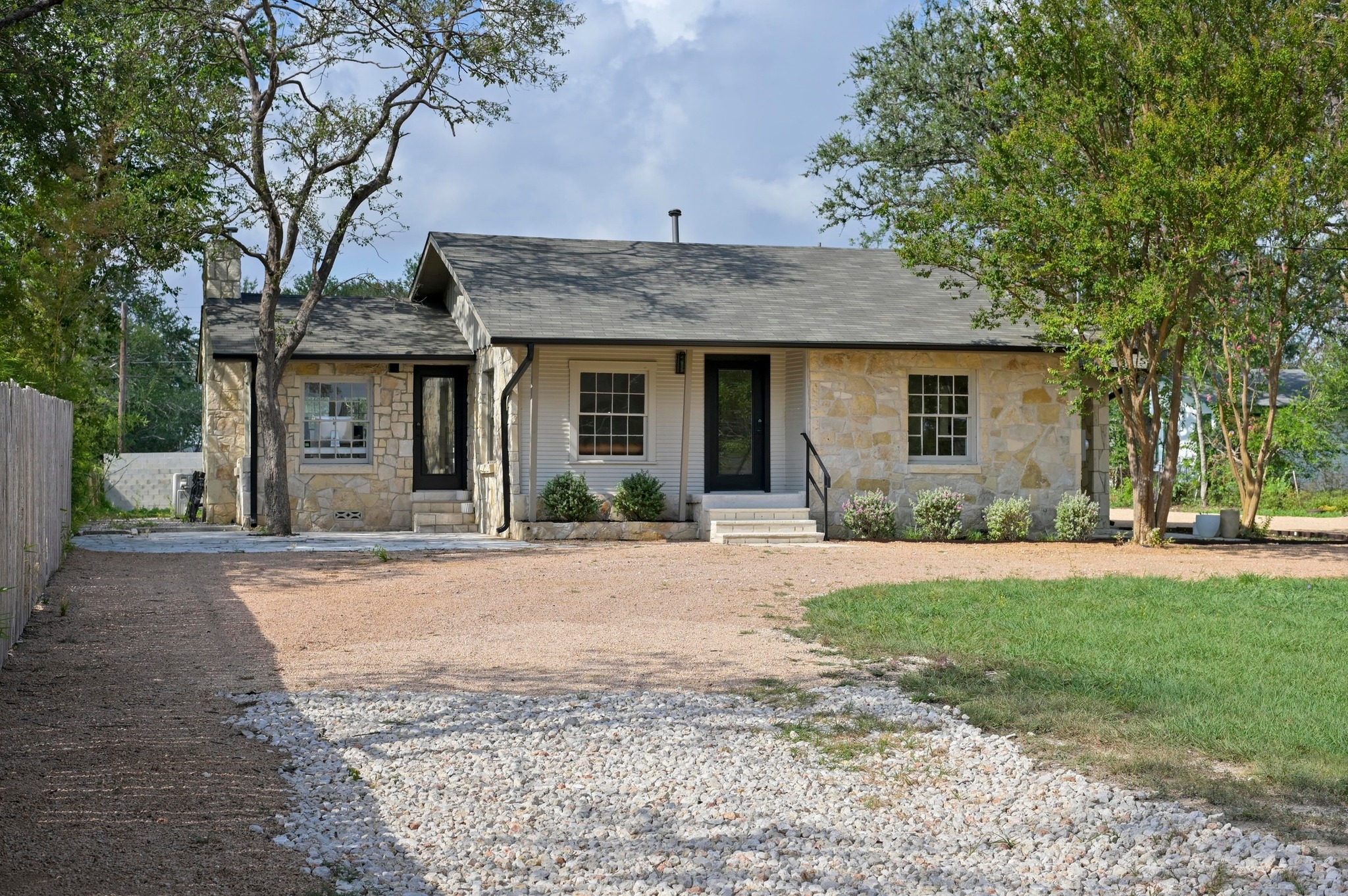 3501 Pecan Springs Road Austin, TX 78723 - Photo 4 of 40 Single story home featuring stone siding, covered porch, a chimney, and a shingled roof