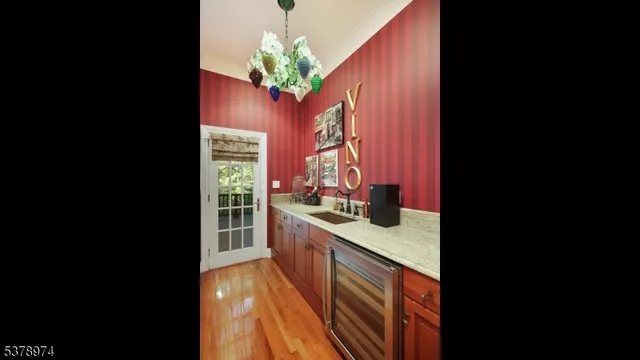 a bedroom with a bed dresser and a flat tv screen