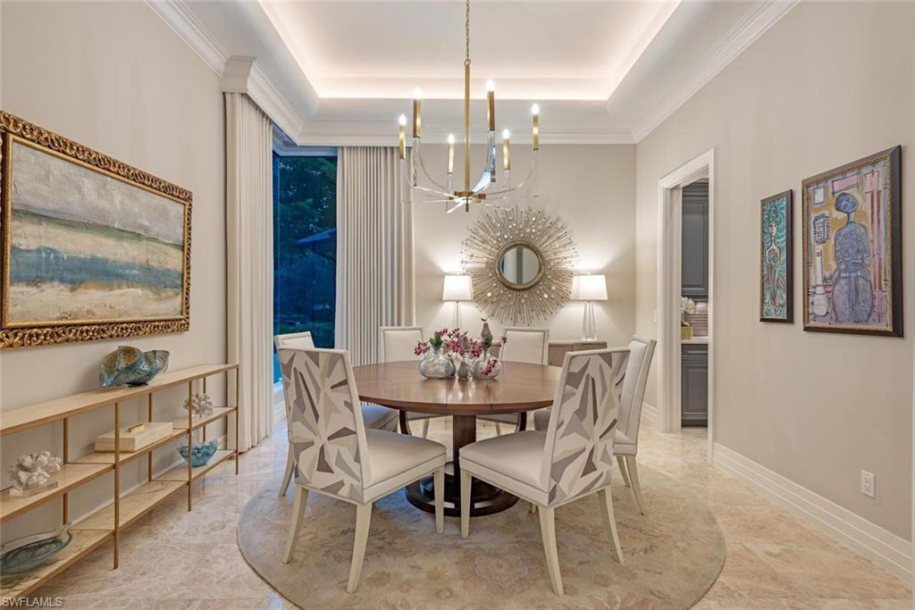 2701 Buckthorn Way Naples, FL 34105 - Photo 12 of 48 a view of a dining room with furniture and chandelier