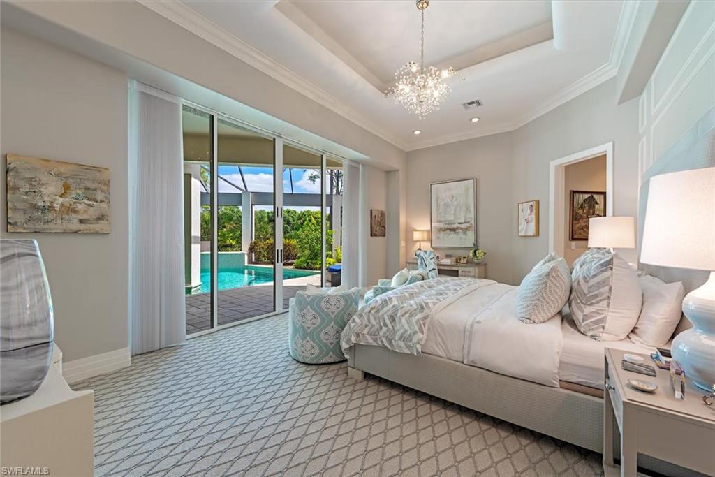2701 Buckthorn Way Naples, FL 34105 - Photo 15 of 48 a bedroom with a large bed and a window