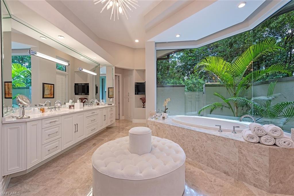 2701 Buckthorn Way Naples, FL 34105 - Photo 16 of 48 a large white kitchen with a large tub and sink