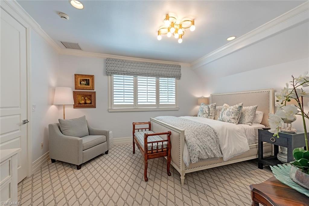 2701 Buckthorn Way Naples, FL 34105 - Photo 19 of 48 a spacious bedroom with a bed and a couch
