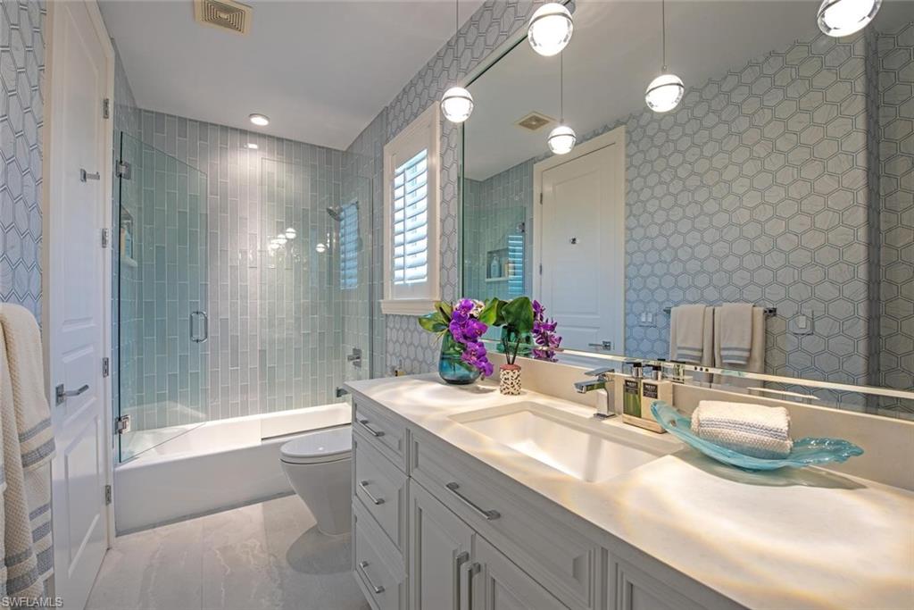 2701 Buckthorn Way Naples, FL 34105 - Photo 20 of 48 a bathroom with a double vanity sink mirror and shower