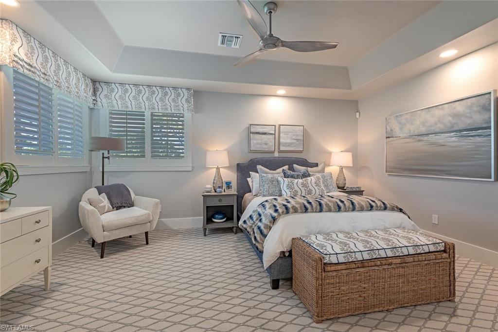 2701 Buckthorn Way Naples, FL 34105 - Photo 21 of 48 a bedroom with a large bed and a couch