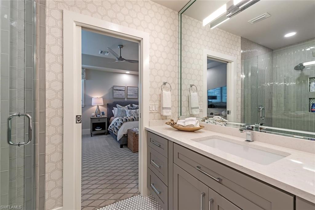 2701 Buckthorn Way Naples, FL 34105 - Photo 22 of 48 a en suite bathroom with a sink and mirror
