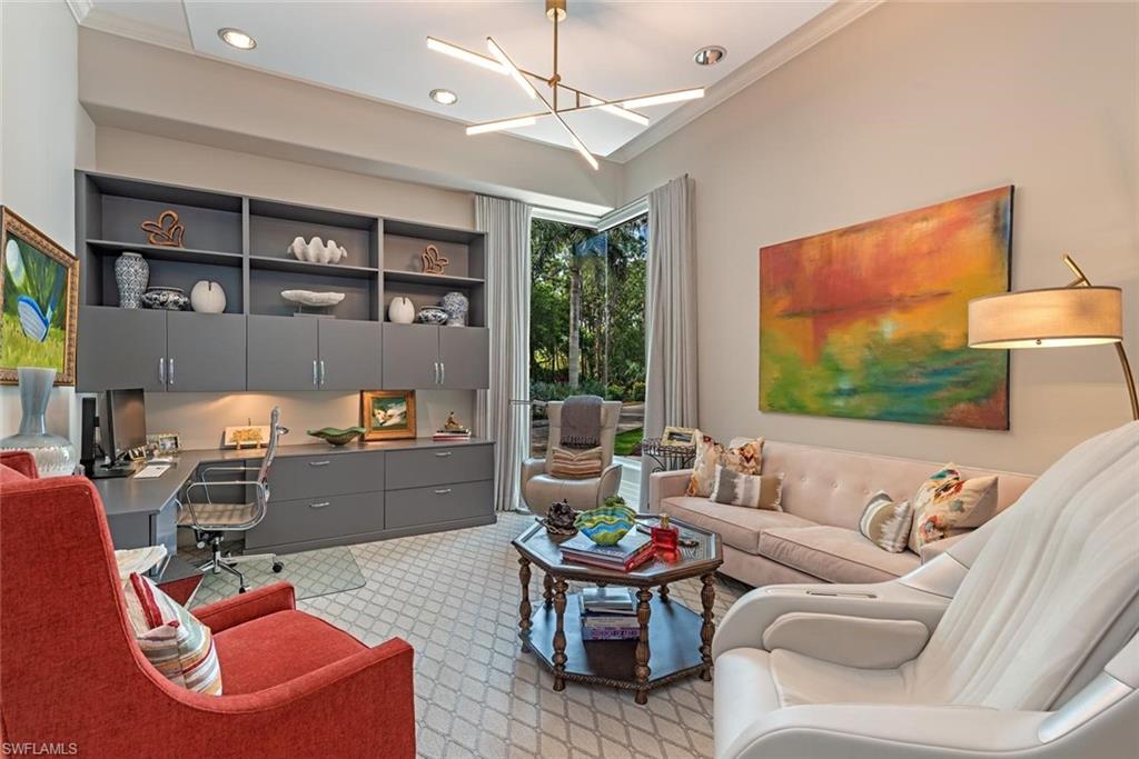 2701 Buckthorn Way Naples, FL 34105 - Photo 23 of 48 a living room with furniture and a flat screen tv