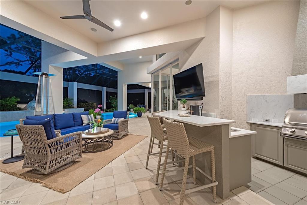 2701 Buckthorn Way Naples, FL 34105 - Photo 25 of 48 a view of a livingroom with furniture and a flat screen tv