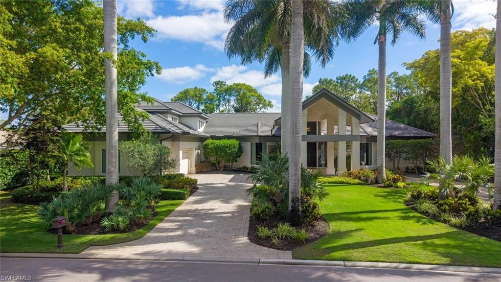 2701 Buckthorn Way Naples, FL 34105 - Photo 30 of 48 a front view of a house with garden