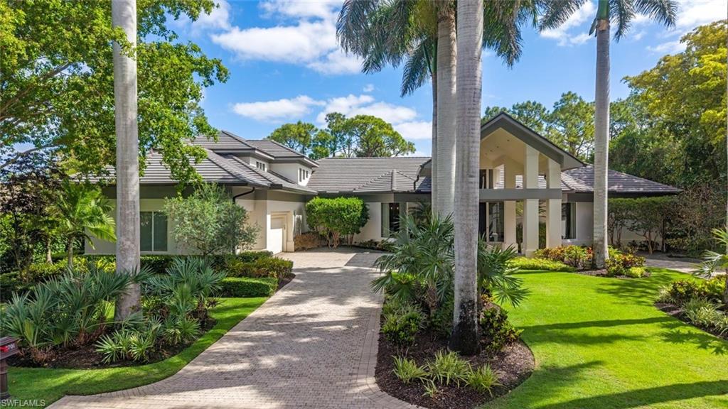 2701 Buckthorn Way Naples, FL 34105 - Photo 3 of 48 a front view of a house with garden