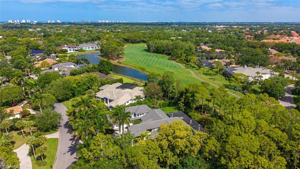 2701 Buckthorn Way Naples, FL 34105 - Photo 31 of 48 an aerial view of residential house with outdoor space and trees all around