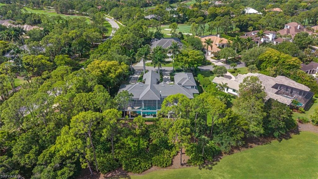 2701 Buckthorn Way Naples, FL 34105 - Photo 34 of 48 an aerial view of a house with a yard and lake view