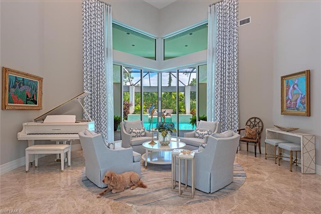 2701 Buckthorn Way Naples, FL 34105 - Photo 6 of 48 a living room with furniture and a large window