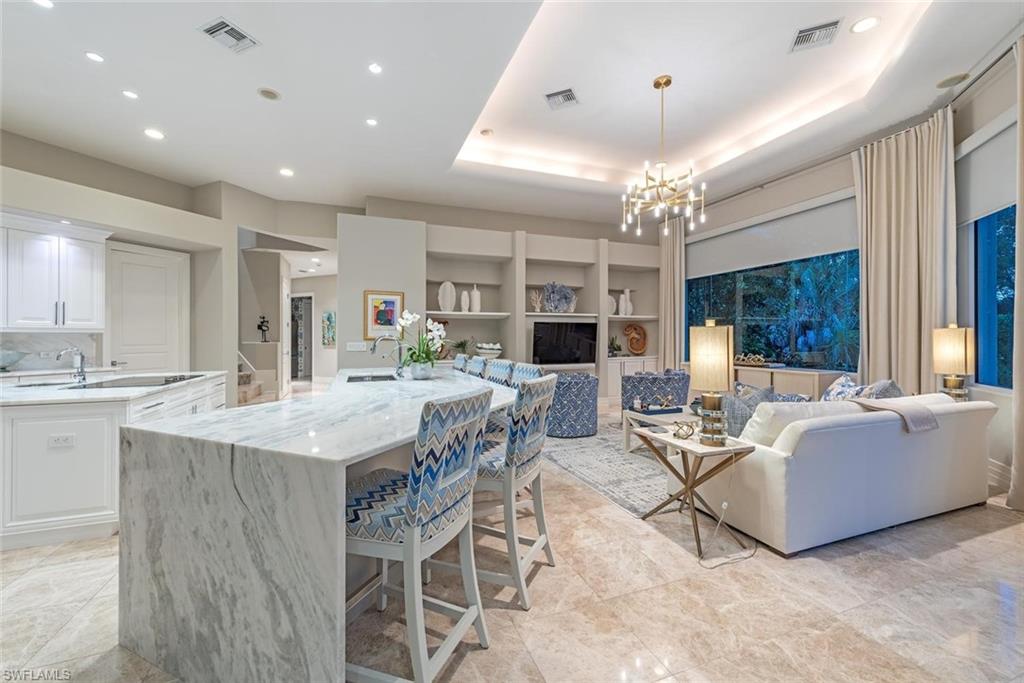 2701 Buckthorn Way Naples, FL 34105 - Photo 10 of 48 a view of a dining room with furniture window and wooden floor