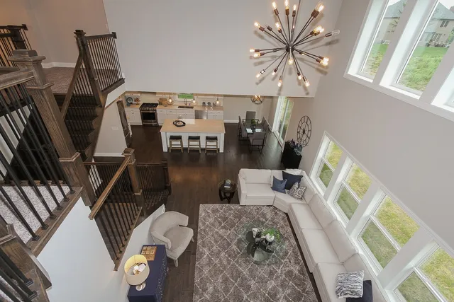 a living room with furniture and a floor to ceiling window