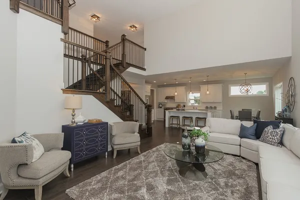 a living room with furniture and a dining table