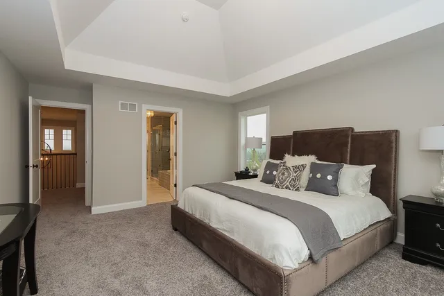 a bedroom with a bed and lamp