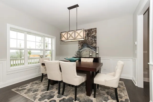 a view of a dining room with furniture wooden floor and a chandelier