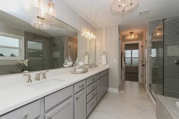 a bathroom with a sink double vanity and a shower
