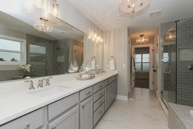 a bathroom with a sink double vanity and a shower