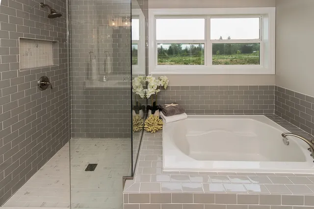 a bath tub sitting next to a window