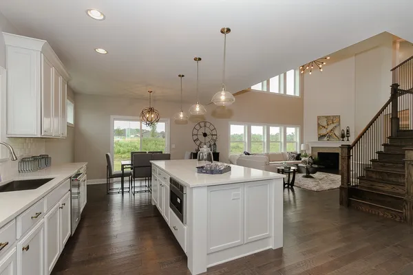 a kitchen with sink stove and cabinets