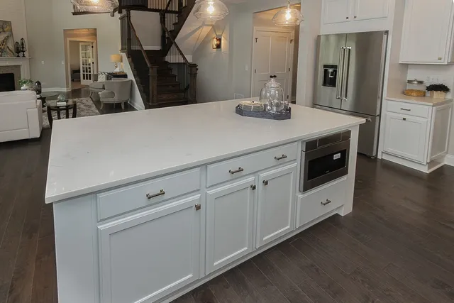 a kitchen with cabinets and wooden floor