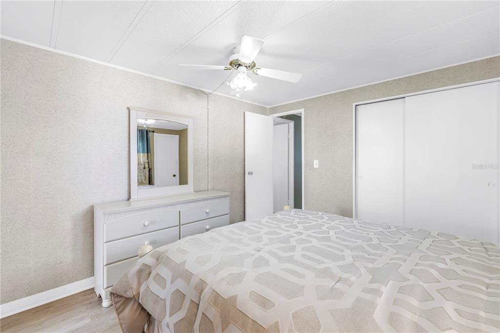 1100 South Belcher Road, Unit 502 Largo, FL 33771 - Photo 23 of 51 a bedroom with a large bed and a chandelier